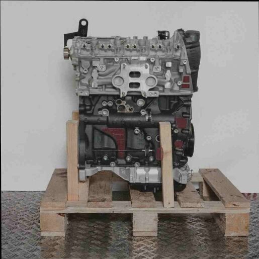 Motor DKNA auf Holzpalette vor weißem Hintergrund. Vertikale Aufnahme des Motors mit schwarzen und silbernen Komponenten.